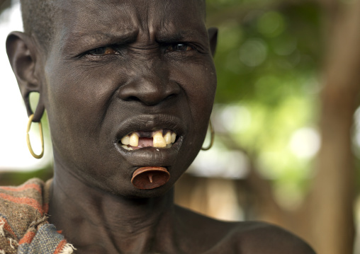 Portrait Of A Old Bodi Tribe Woman With Tooth Gap And Chin Pin, Hana Mursi Village, Omo Valley, Ethiopia