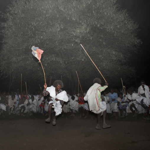 Night Shot Of Two Karrayyu Tribe Men During A Choreographed Stick Fighting Dance At Gadaaa Ceremony, Metahara, Ethiopia