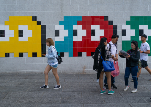 Invader pac-man mosaics on a wall in the street, Kowloon, Hong Kong, China