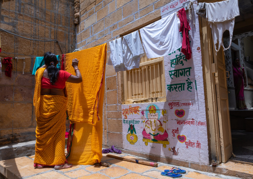 Indian woman hanging saris, Rajasthan, Jaisalmer, India