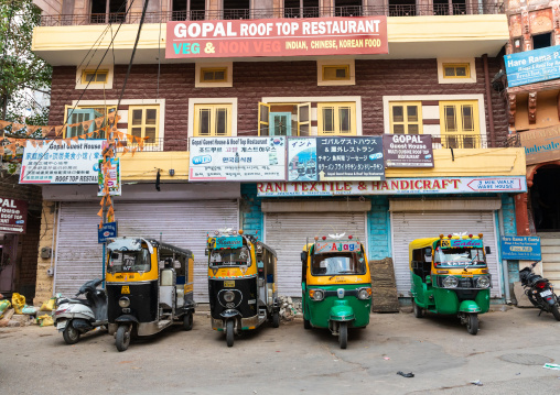 Yellow auto rickshaws lined up in the street, Rajasthan, Jodhpur, India