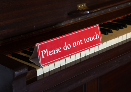 Piano with a sign do not touch in the city palace, Rajasthan, Udaipur, India