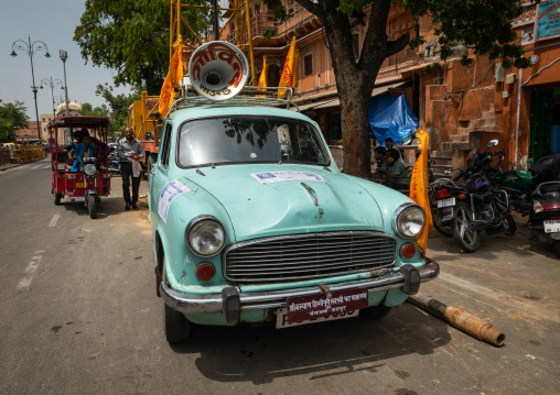 Old green car with a loudspeaker on the roof, Rajasthan, Jaipur, India