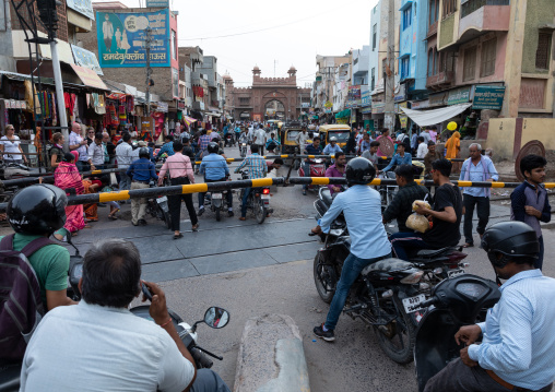 Indian riders ride motorbikes on busy road, Rajasthan, Bikaner, India