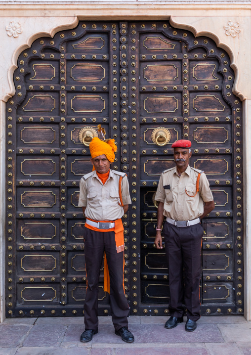 Indian guards in front of an old door in the city palace, Rajasthan, Jaipur, India