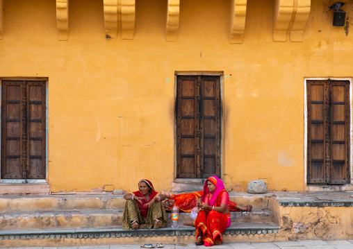 Indian women sit in Amer fort and palace, Rajasthan, Amer, India
