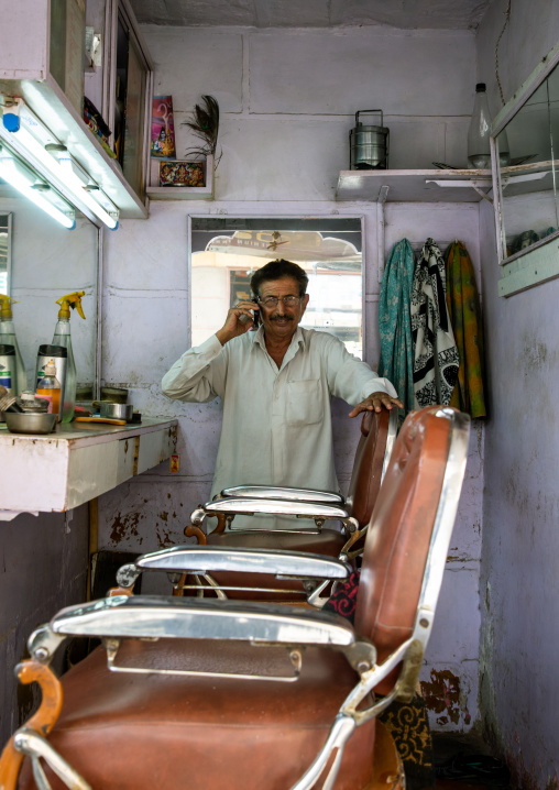 Street barber in his shop, Rajasthan, Jaisalmer, India