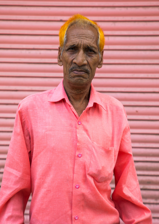 Indian man with henna on the hair and pink shirt, Rajasthan, Jaipur, India