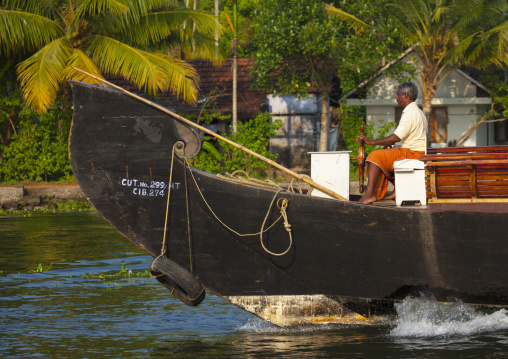 Men At The Helm Of A Houseboat On Kerala Backwaters, Alleppey, India