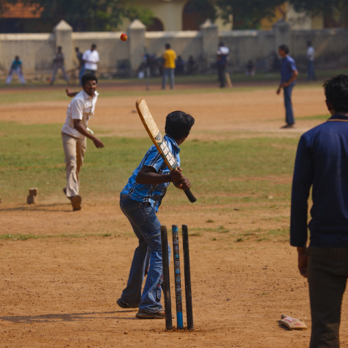 Group Of Young Men Practicing Cricket On A Public Ground, Kochi, India