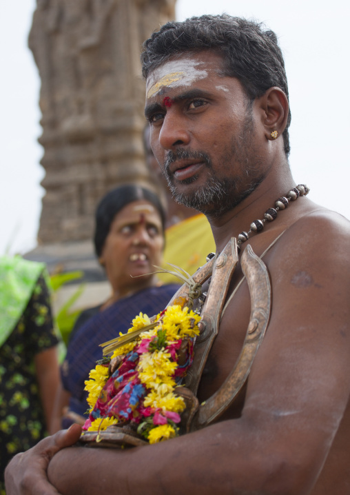 Priest Holding A Small Statue Of Shiva And His Trishula Adorned With Flowers During The Masi Magam Festival, Pondicherry, India