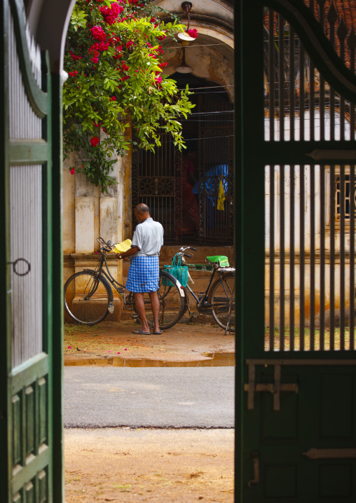 Man And His Bicycle Seen From A Past Old House Entrance In Kanadukathan Chettinad, India