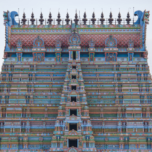 Top Of One Colorful Gopuram With Numerous Carved Figurines At The Sri Ranganathaswamy Temple, Trichy, India