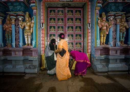 Three Women In Sari Putting Offers In Front Of The Decorated Entrance Of The Sri Ranganathaswamy Temple, Trichy, India