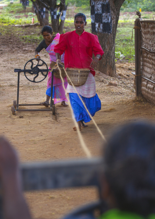 Indian Women Making Ropes With An Old Weaving Loom In A Village Near Madurai, India