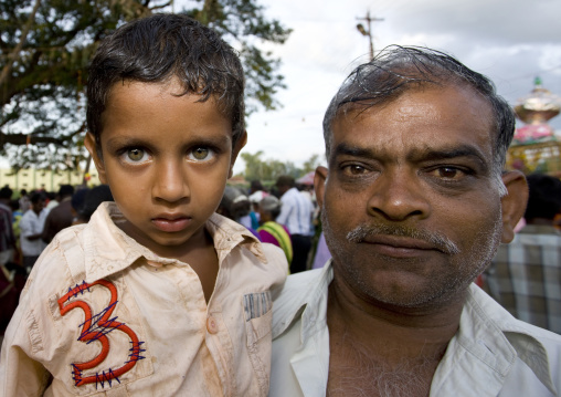 Man Carrying A Boy With Clear Eyes On His Arms Attending Fire Walking Ritual, Madurai, South India