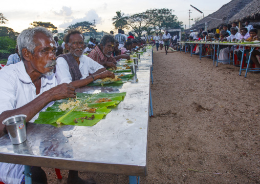 Group Of People Eating Rice During A Collective Meal After Fire Walking Ceremony, Madurai, India