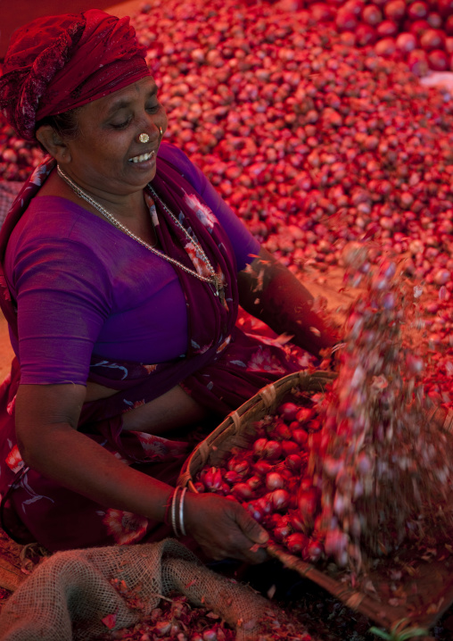 Red Onions Seller Preparing Her Stalls At The Madurai Market, India