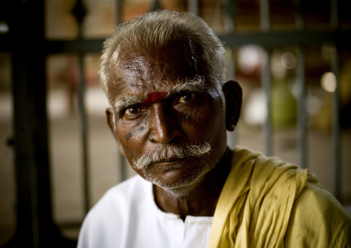 Old Indian Matchmaker With Gray Hair And A Mustache Looking For Bachelors In A Temple, Madurai, India