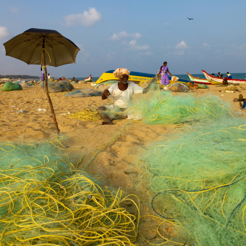 Mahabalipuram Fishermen On The Beach Mending Nets, India