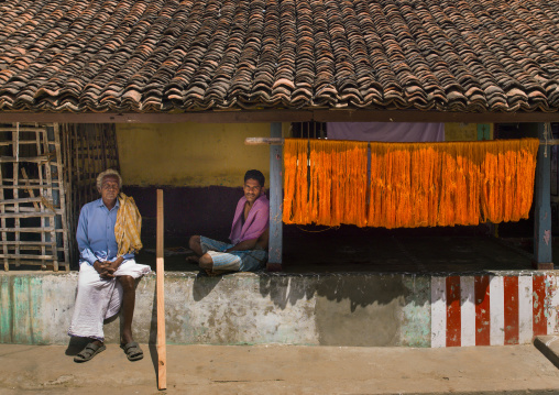 Men Sitting On The Wall In Front Of Their House With A Tiled Roof, Kumbakonam, India