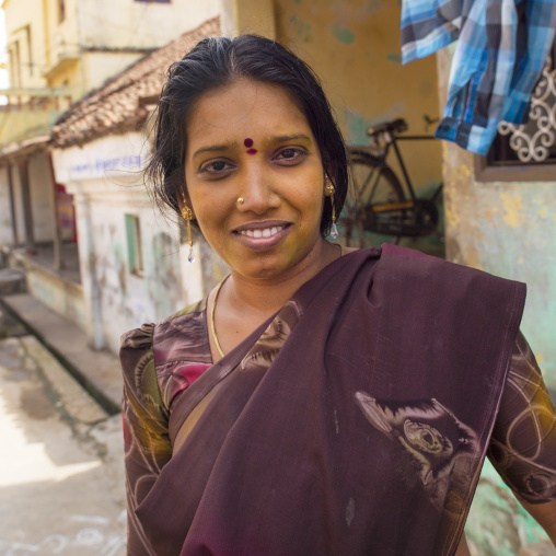 Indian Woman In Sari With Bindi On Her Forehead Posing In The Middle Of The Street And Smiling Shyly, Kumbakonam, India
