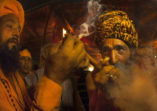 A Naga Sadhu Smoking Pot, Maha Kumbh Mela, Allahabad, India