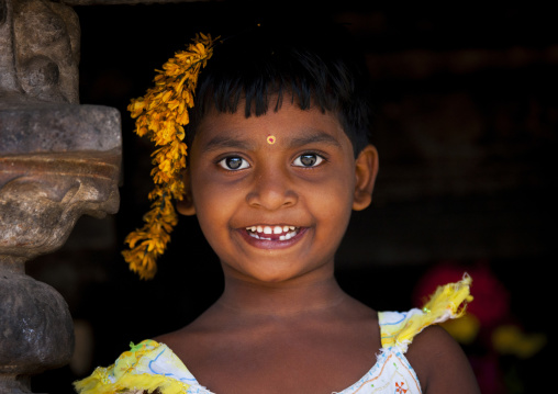 Portait Of A Smiling Gap-toothed Young Girl With Flowers In Her Hairs, Kumbakonam, India