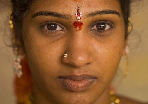 Close Up Of A Young Indian Woman With Traditional Painting On Her Forehead And A Nose Piercing, Madurai, India