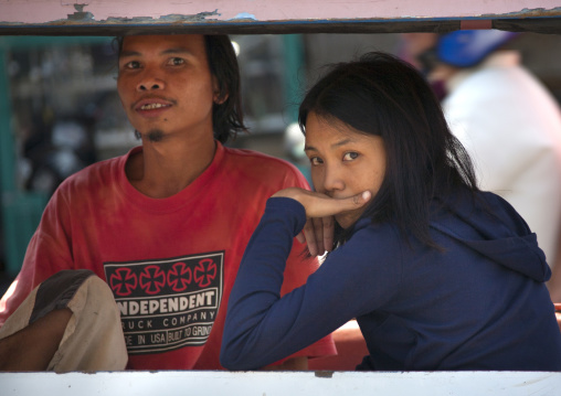 Two Young Adults In A Rickshaw, Mataram, Lombok Island, Indonesia