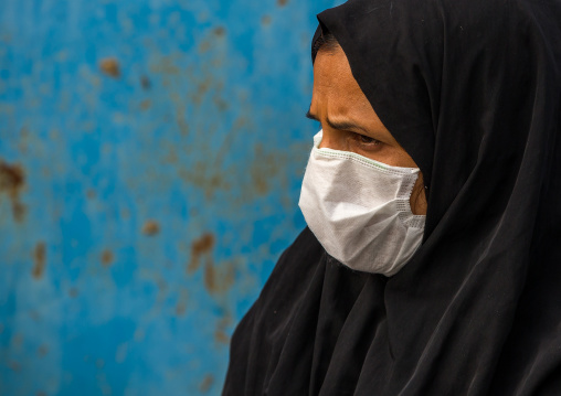 a woman wearing a face mask to protect from h1n1 influenza in panjshambe bazar, Hormozgan, Minab, Iran