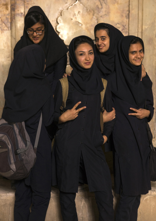 Iranian women pausing for pictures inside the friday mosque, Isfahan province, Isfahan, Iran
