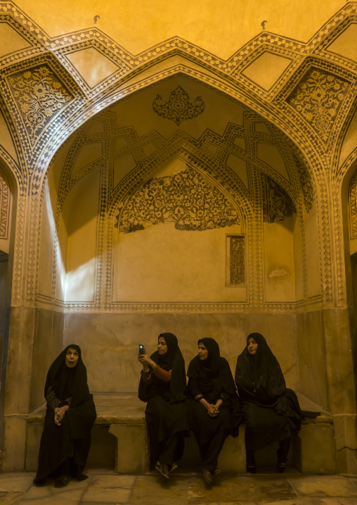 Iranian women taking pictures in the karim khan fort bath, Fars province, Shiraz, Iran