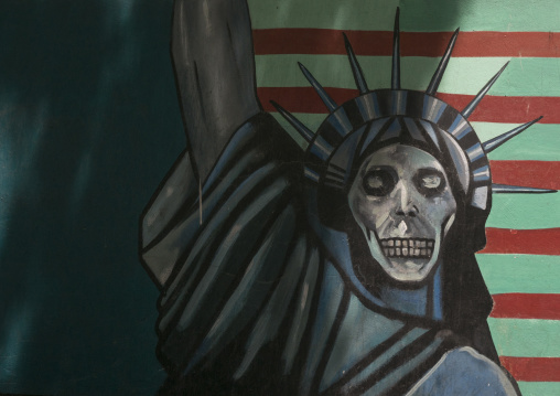Anti-american mural propoganda slogan depict statue liberty skeleton on the wall of the former united states embassy, Shemiranat county, Tehran, Iran