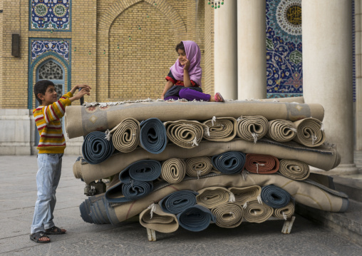 Children playing with carpets in fatima al-masumeh shrine, Qom province, Qom, Iran