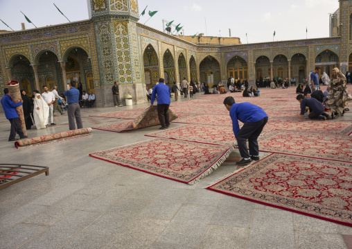 Men putting carpets for praying in the shrine of fatima al-masumeh, Qom province, Qom, Iran