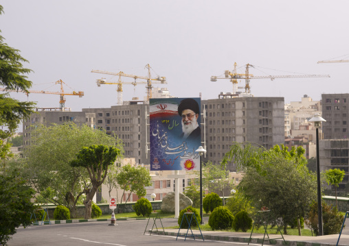 Billboards of khameini in front of cranes, Shemiranat county, Tehran, Iran