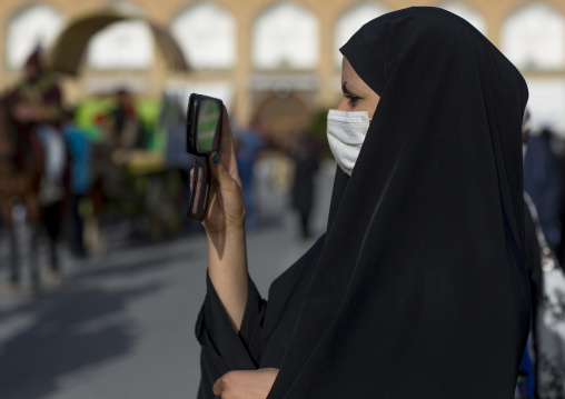 Veiled woman taking pictures with her mobile phone, Isfahan province, Isfahan, Iran