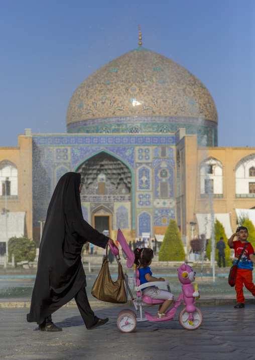 Veiled mother pushing a baby cart in naghsh-i jahan square, Isfahan province, Isfahan, Iran