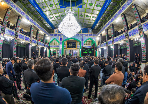Iranian shiite muslim mourners chanting  during Muharram inside a hosseinieh, Yazd Province, Yazd, Iran