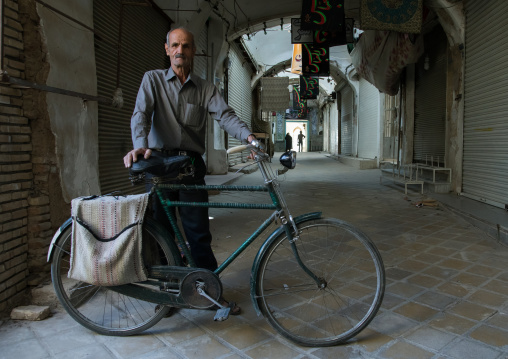 Old man with his bicycle in the empty bazaar, Yazd Province, Yazd, Iran