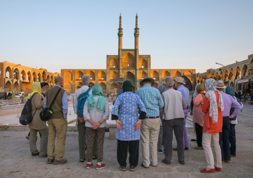 Tourists in front of the three-storey takieh part of the Amir chakhmaq complex, Yazd Province, Yazd, Iran