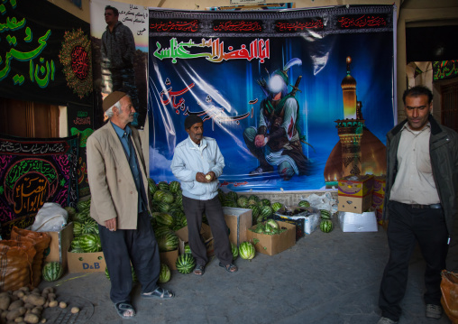 Iranian shiite men in front of a Muharram decoration in the bazaar, Isfahan Province, Nain, Iran