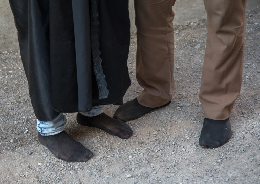 An iranian shiite couple walks in stocking feet during the Chehel Manbar ceremony a day before Ashura, Lorestan Province, Khorramabad, Iran