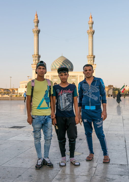 Iraqi pilgrims teenagers with fashionnable clothes in front of Imam Hassan mosque during Muharram, Central County, Qom, Iran