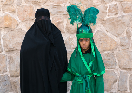 Shhite iranian mother and her son in costume to celebrate Muharram, Lorestan Province, Khorramabad, Iran