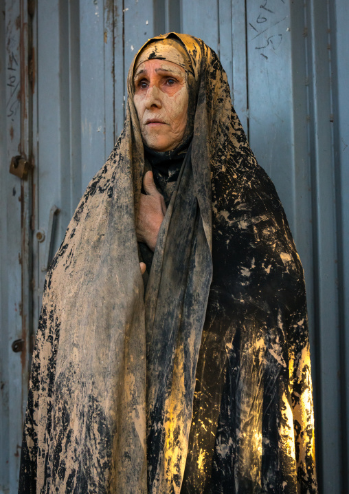 Iranian shiite muslim woman after rubbing mud on her chador during the Kharrah Mali ritual to mark the Ashura ceremony, Lorestan Province, Khorramabad, Iran