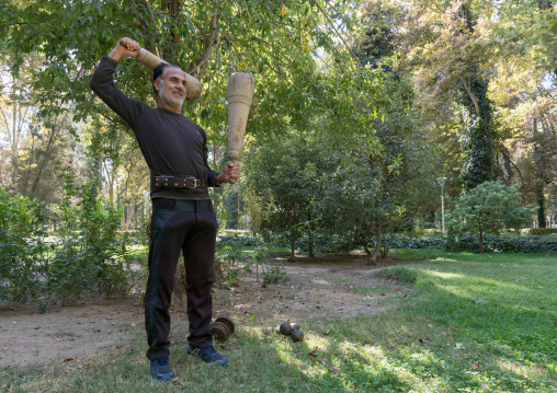Iranian man  training with clubs in Chehel Sotoun gardens, Isfahan Province, Isfahan, Iran