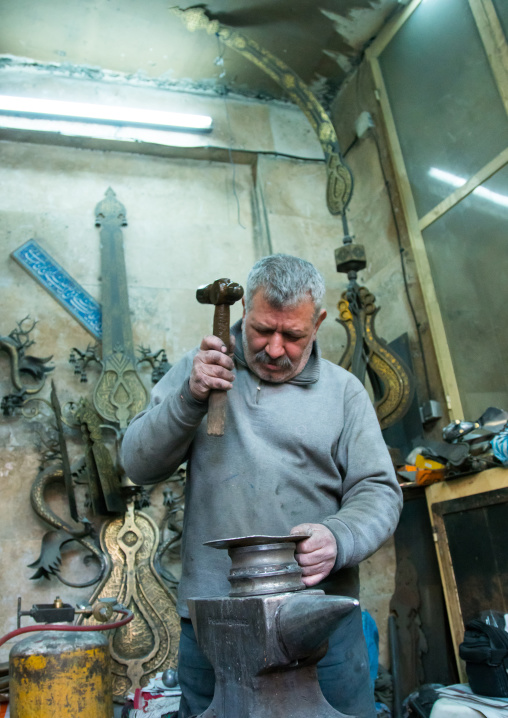 master safar fooladgar creating an alam in his workshop, Central district, Tehran, Iran