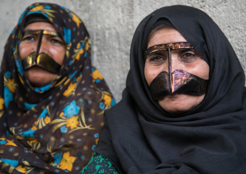bandari women wearing the traditional masks called the burqas with a moustache shape, Qeshm Island, Salakh, Iran